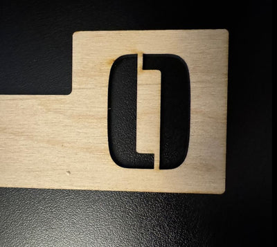 Tab style engraved baltic birch wooden record divider with a  cut out letter O.
